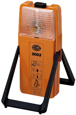 HELLA 2XW 007 146-001 Kombinierte Warnblink- und Arbeitsleuchte mit schwarzem Befestigungshalter. Lichtscheibe für Warnblinklicht gelb. Arbeitslicht weiß. Durch Betätigen des Schalters oberhalb mit Glühlampe